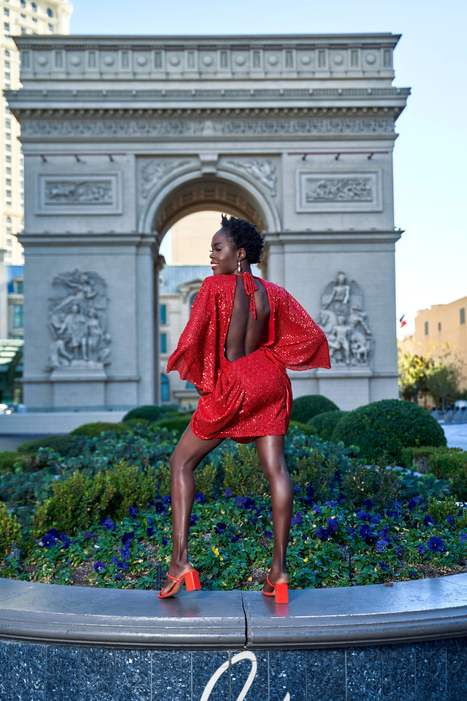 Las Vegas portrait photography — red sequin dress on a fountain in Las Vegas